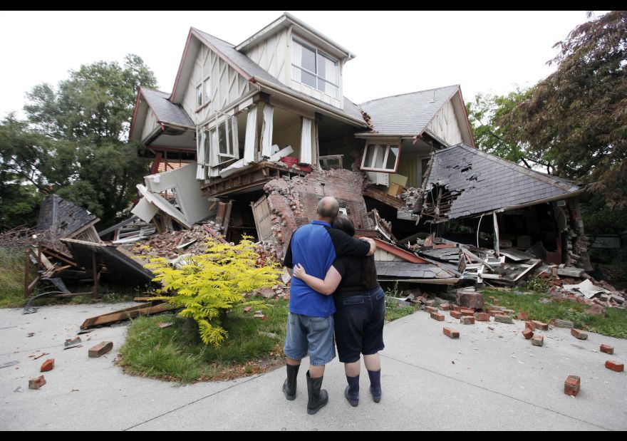 FILE - In this Feb. 23, 2011 file photo Murray, left, and Kelly James look at their destroyed house in central Christchurch, New Zealand, a day after a deadly earthquake. A powerful earthquake struck New Zealand on Monday, Nov. 14, 2016, reminding many of the quake that hit the nation in February 2011 and devastated the city of Christchurch, the country’s second-biggest city. (AP Photo/Mark Baker, File)