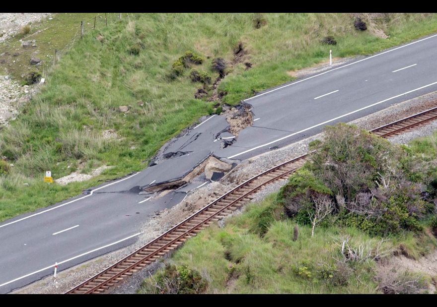 This aerial photo taken and received on November 14, 2016 shows earthquake damage to State Highway One near Ohau Point on the South Island's east coast. A powerful 7.8-magnitude earthquake killed two people and caused massive infrastructure damage in New Zealand, but officials said on November 14 they were optimistic the death toll would not rise further. The jolt, one of the most powerful ever recorded in the quake-prone South Pacific nation, hit just after midnight near the South Island coastal town of Kaikoura. / AFP / POOL / Mark MITCHELL